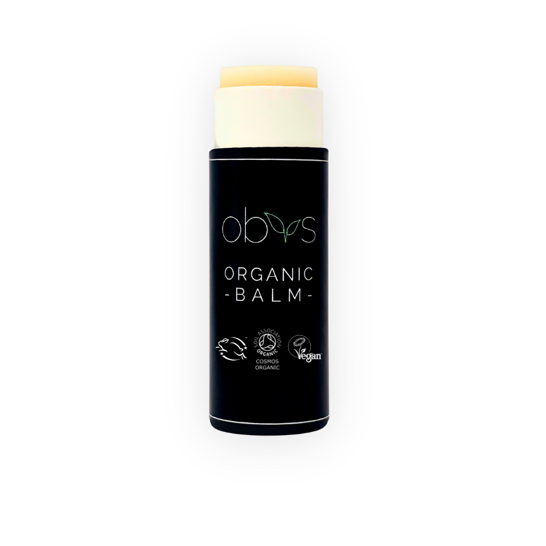 Organic balm with black container and visible branding on a white background