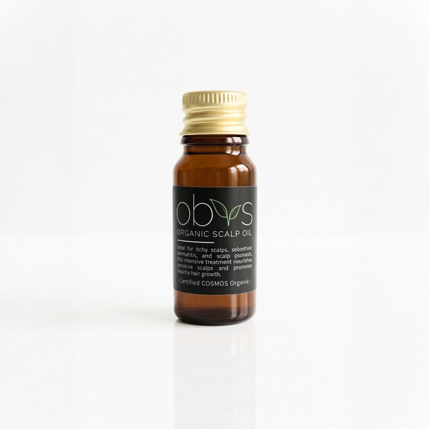 Bottle of organic scalp oil with a gold cap on a white background