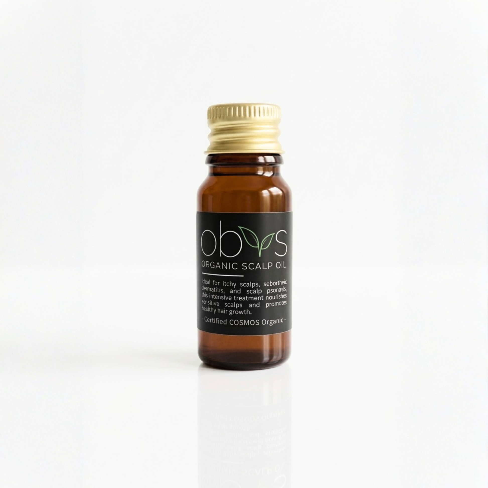 Bottle of organic scalp oil with a gold cap on a white background