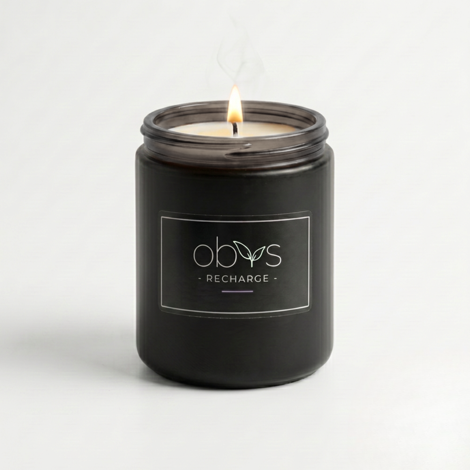Black candle jar with 'obvs' branding on a white background