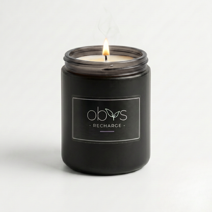 Black candle jar with 'obvs' branding on a white background
