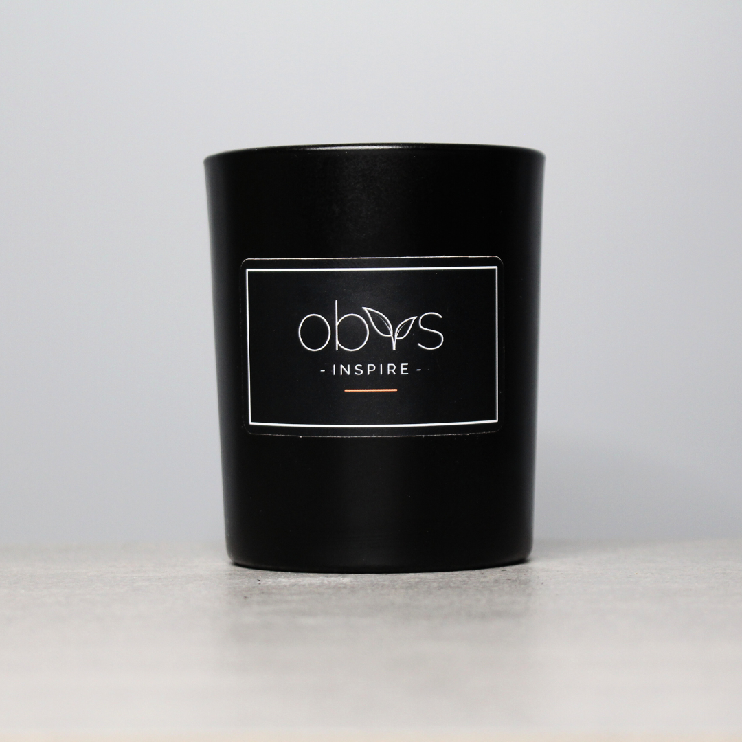 A set of eco-luxury candles with natural wax, elegantly housed in reusable containers, creating a warm, inviting ambiance. Perfect for a sustainable, high-end home aesthetic.