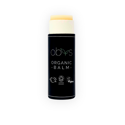 Organic balm with black container and visible branding on a white background